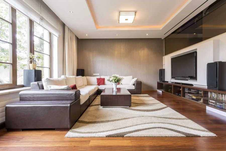 Stylish living room featuring freshly painted accent wall, contemporary ceiling trim lighting, and coordinated furniture decor enhancements
