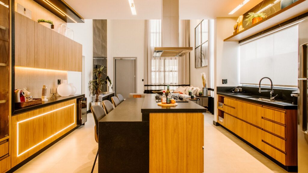 Modern Ontario kitchen showcasing 2025 kitchen design trends with statement island, wood cabinetry, bold lighting, and sleek countertops.