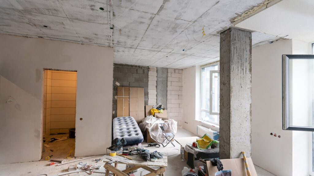 Whole-home renovation mistakes shown in a Mississauga house under construction with exposed walls, unfinished ceilings, and cluttered remodel work.