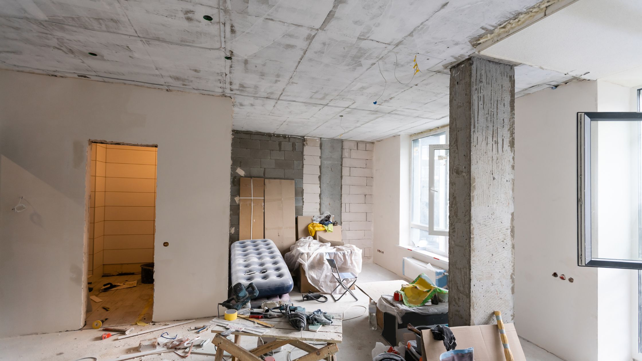 Whole-home renovation mistakes shown in a Mississauga house under construction with exposed walls, unfinished ceilings, and cluttered remodel work.