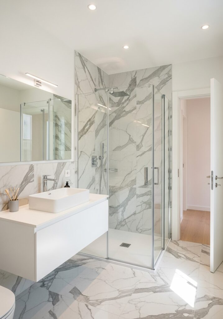 Toronto bathroom remodel with modern walk-in shower, marble tile walls, and floating vanity by RM Renovation.